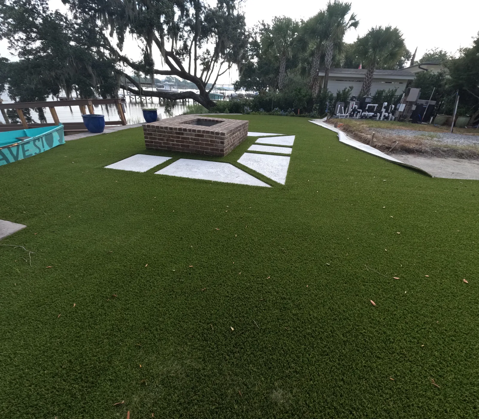 Backyard fire pit on artificial turf by Cramers Landscaping, Charleston area
