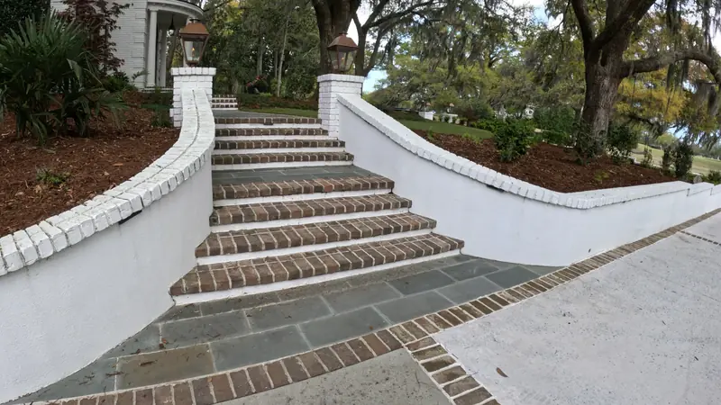 Stucco retaining walls flanking brick front steps in Charleston, SC