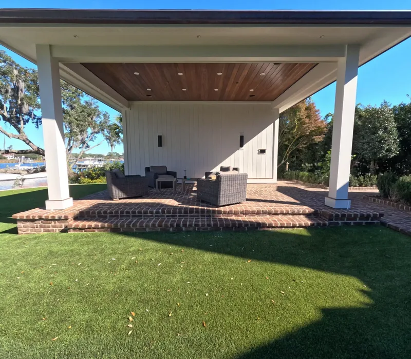 Pavilion on a herringbone brick patio beside an artificial turf lawn in Charleston, SC