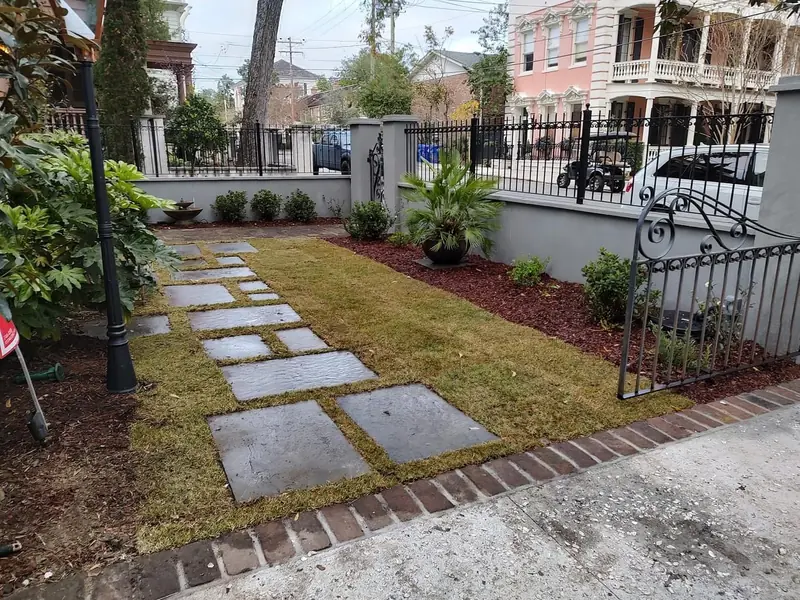 Stucco flood wall with the iron fence set back on top in Charleston, SC