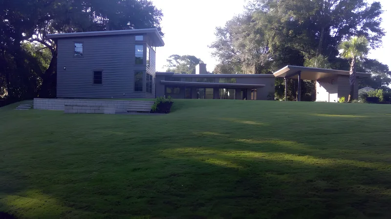 Rear lawn of a modern home at dusk in Mount Pleasant, SC