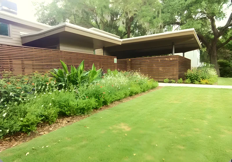 Modern home with a horizontal slat fence and native plantings in Mount Pleasant, SC