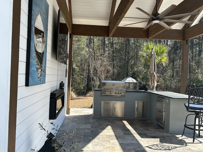 Outdoor kitchen under the glulam beams of a pool pavilion in Mount Pleasant, SC
