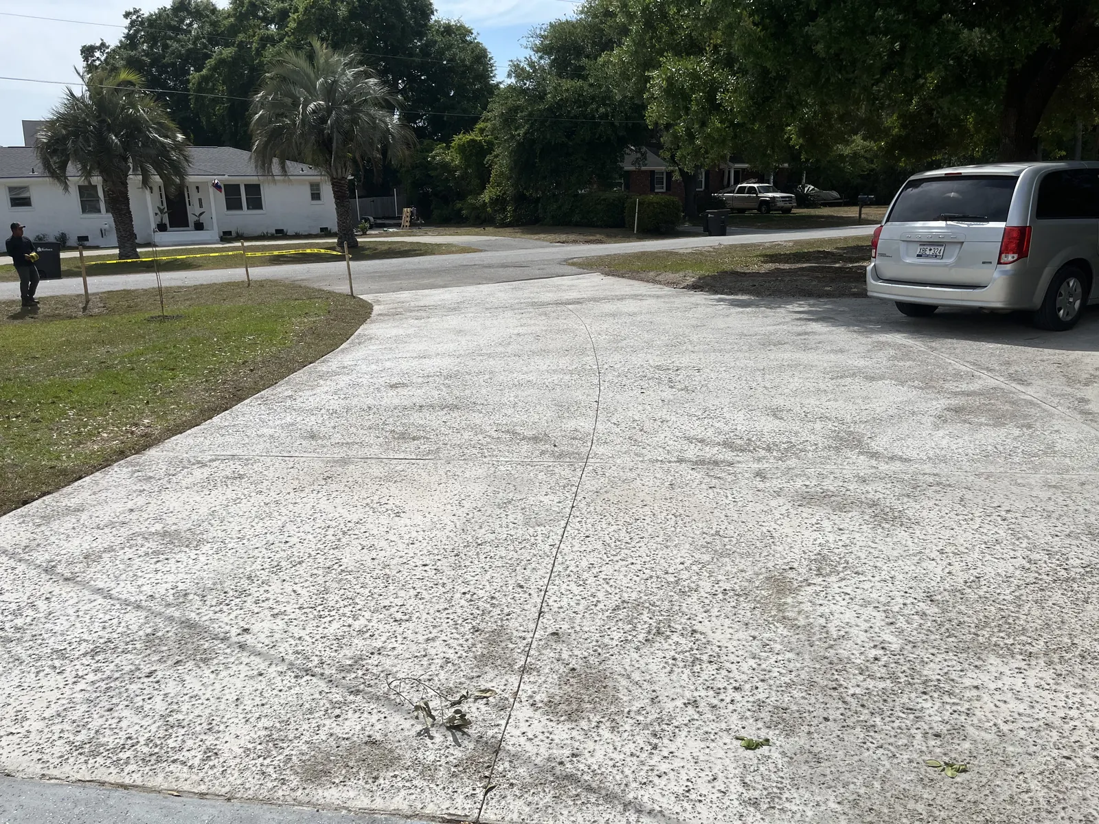 Residential concrete driveway installation in Mount Pleasant, SC Wide poured concrete driveway with cut control joints at a residential home in Mount Pleasant, SC