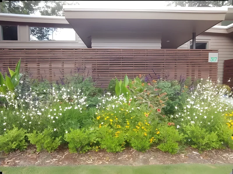 Wildflower border planted along a horizontal slat fence in Mount Pleasant, SC