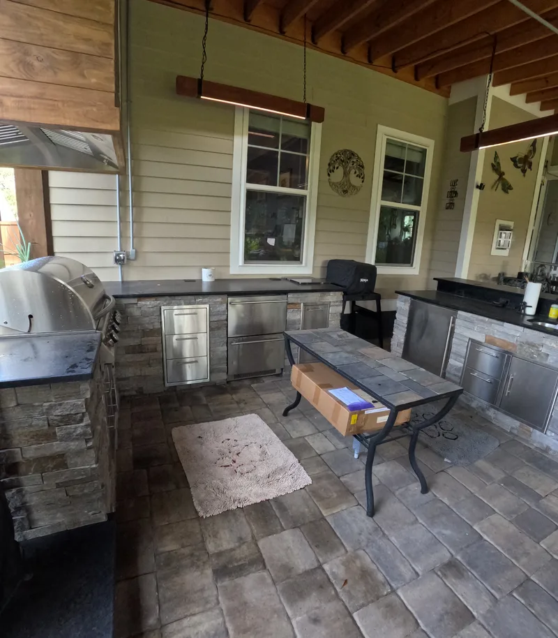 Ledgestone outdoor kitchen with a black granite counter and grill in Summerville, SC