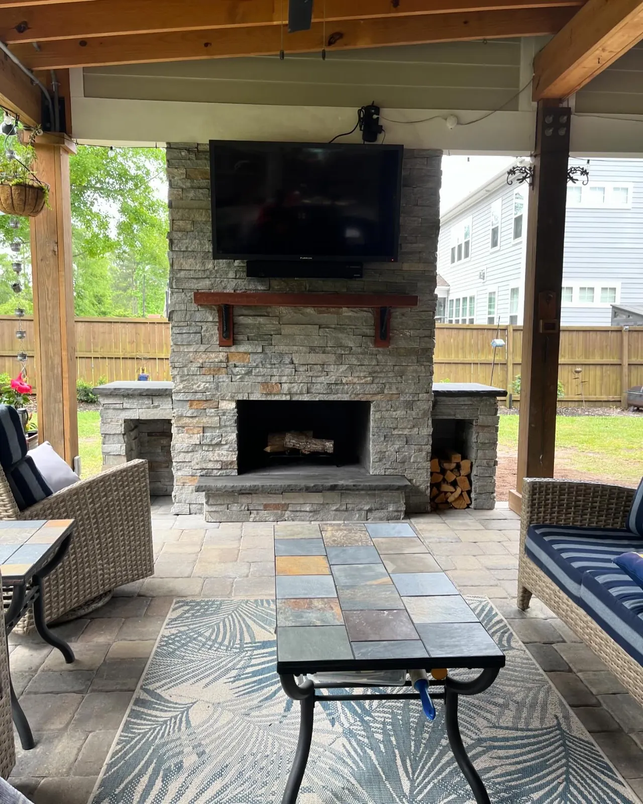 Stone outdoor fireplace patio landscaping in Summerville, SC