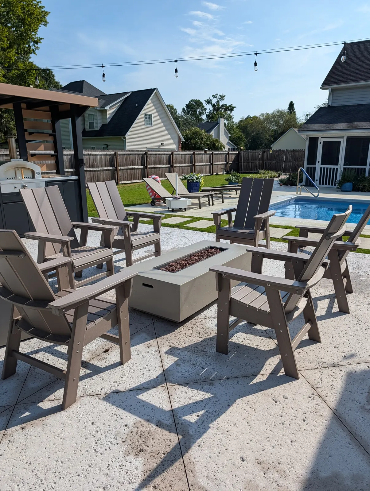 Adirondack chairs around a gas fire table on a poolside patio in West Ashley, SC Adirondack chairs around a gas fire table on a poolside patio in West Ashley, SC
