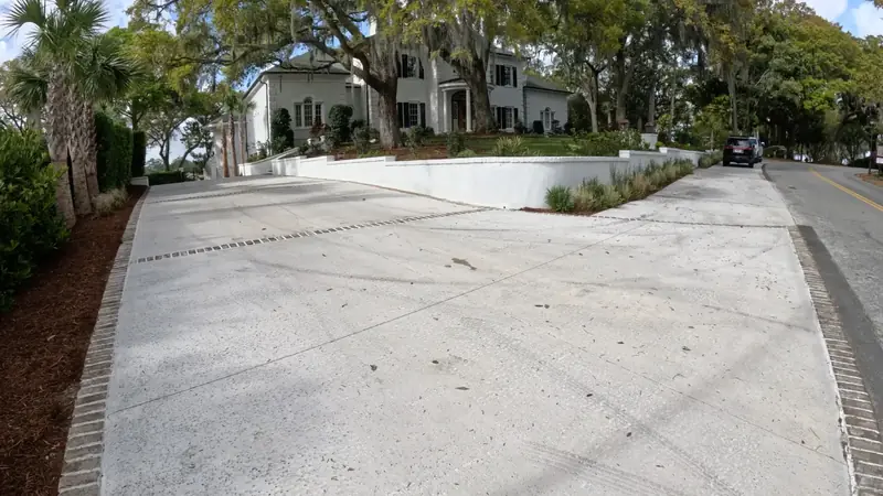 Wide concrete driveway at a shaded entry by Cramers Landscaping, Charleston area