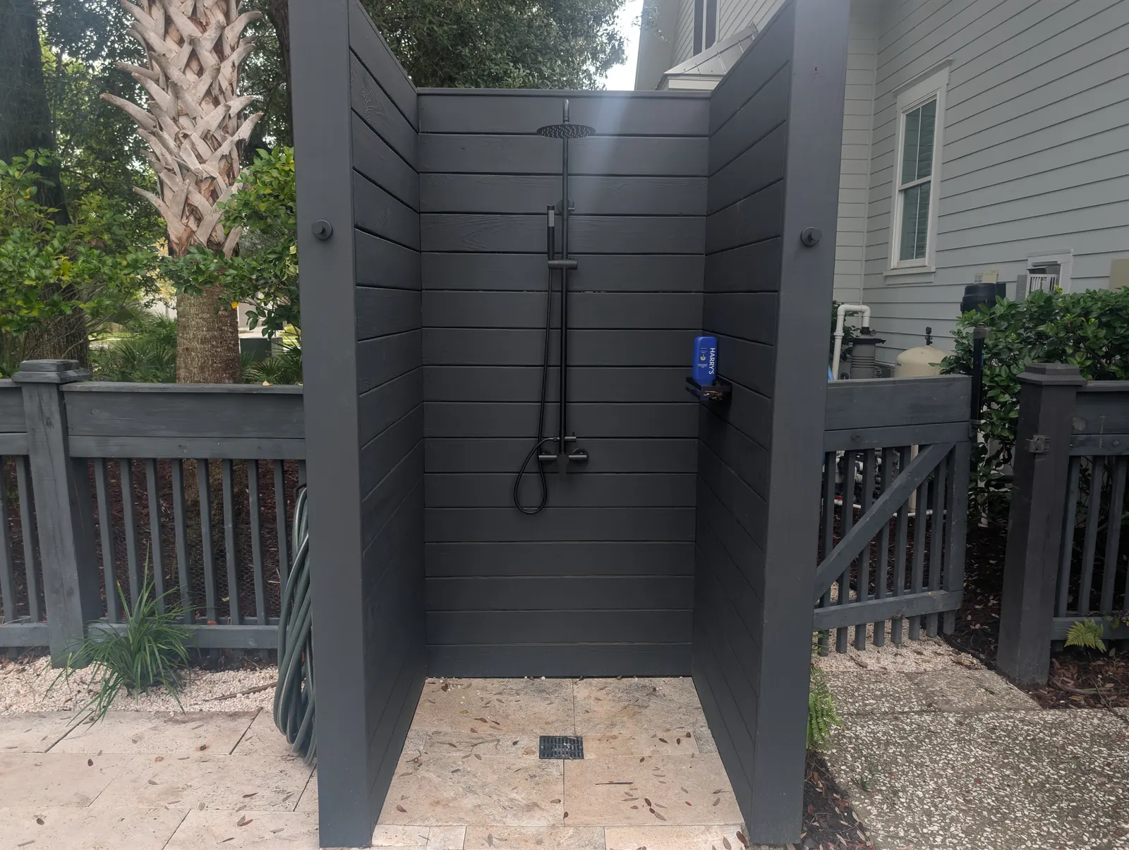 Outdoor shower with a travertine floor in Daniel Island, SC